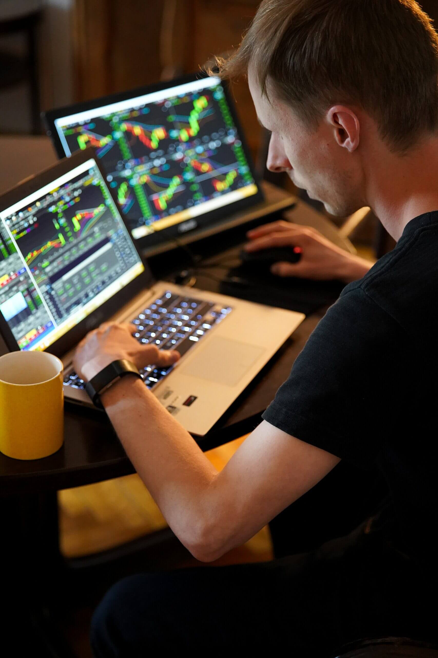 Software designer looking at data on a laptop