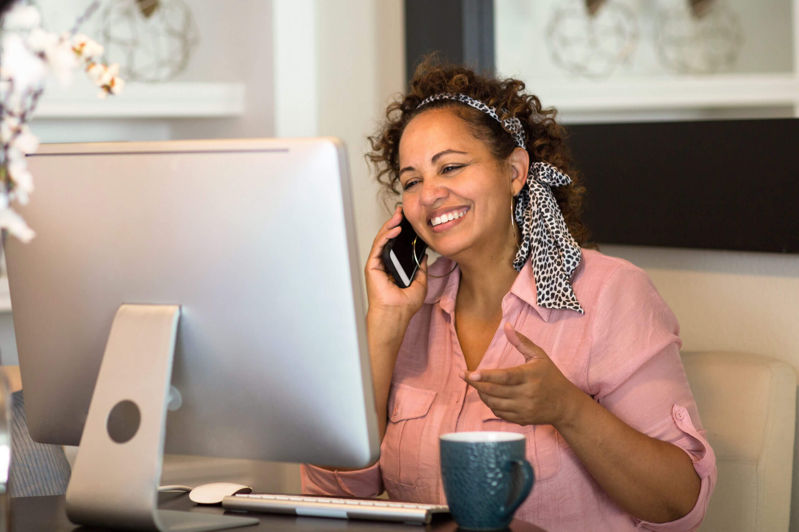 Happy woman working from her home office.